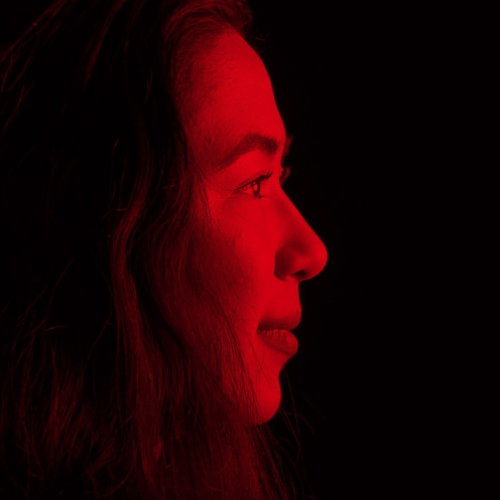 image of a woman's face in red lighting